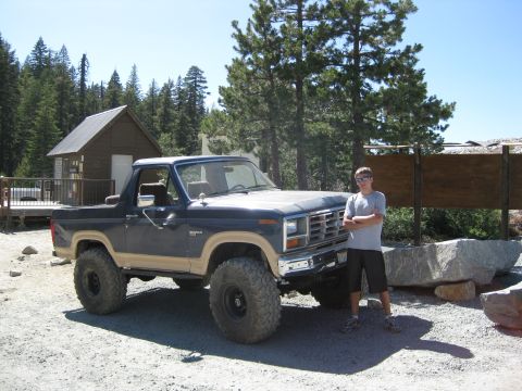 1986 Ford Bronco - A lifted Ford Bronco is parked outdoors with a person standing next to it.