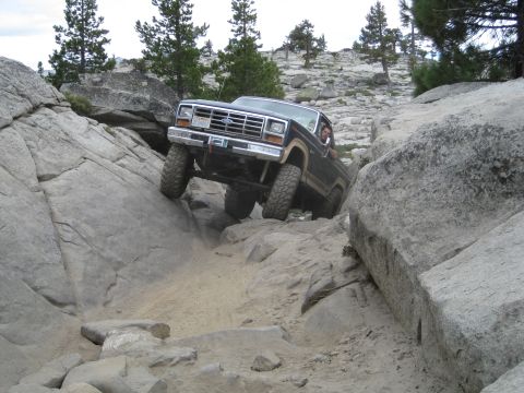 1986 Ford Bronco - This 4x4 navigates a challenging rocky terrain with steep inclines and large boulders.