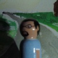 1984 Ford Bronco - Figurine with glasses and beard, part of a larger scene.