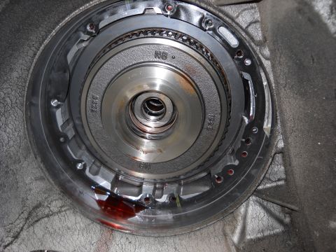 1993 Ford C-150 (Centurion Conversions) - Close-up of a transmission torque converter, showing internal components and some fluid leakage.