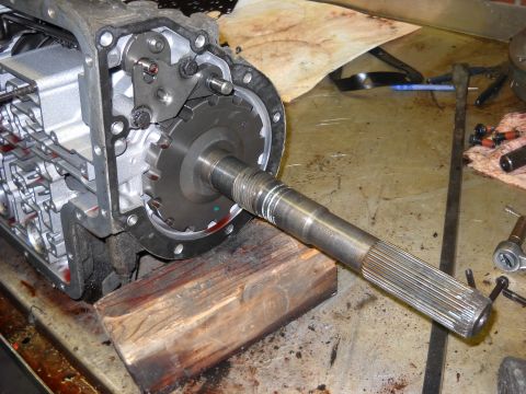 1993 Ford C-150 (Centurion Conversions) - Close-up view of a transmission's internal components, including the input shaft and housing, resting on a wooden block.