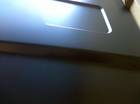 1995 Ford Bronco - A close-up view of a vehicle's hood shows a recessed area with subtle lighting.