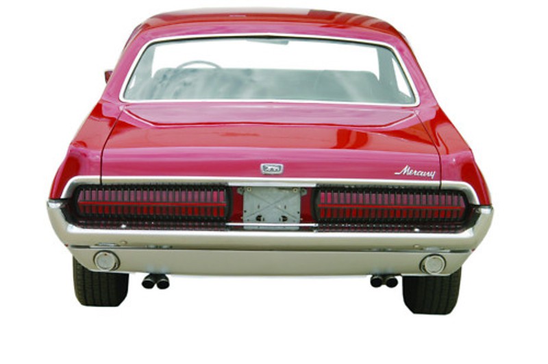 Red Mercury Cougar rear view, segmented tail lamps, dual exhaust, white background