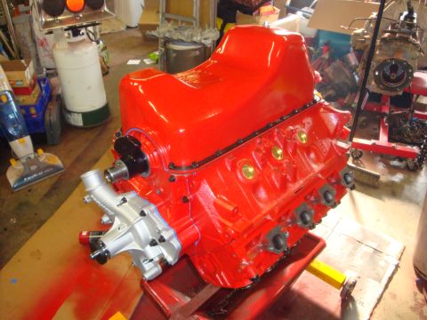 1989 Ford Bronco - A freshly painted V8 engine block sits on an engine stand, ready for assembly.