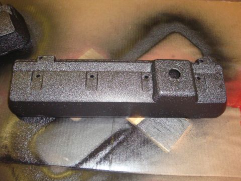 1989 Ford Bronco - Engine valve cover undergoing a textured black paint job.