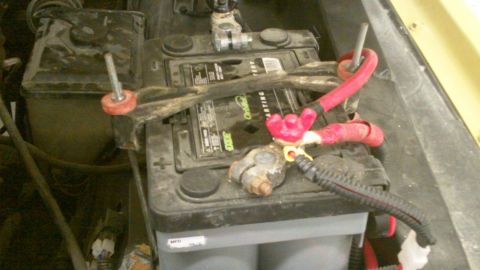 1978 Ford Bronco - Close-up view of a car battery with its associated wiring and terminal connectors.