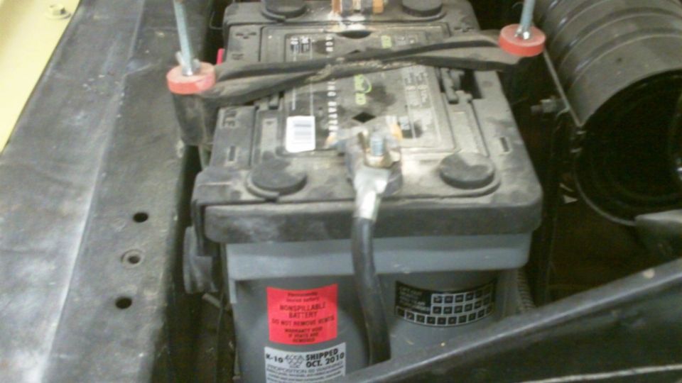 Car battery with red warning sticker and date code OCT 2010