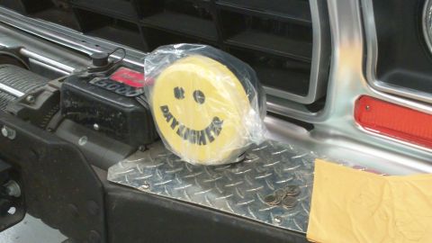 1978 Ford Bronco - A yellow smiley face day lights accessory is visible on a winch, with text reading 'DAY LIGHTS'.