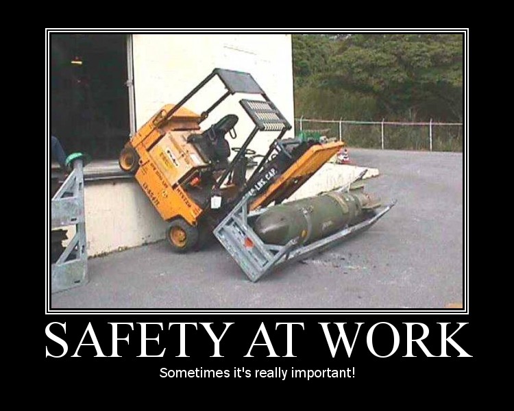 Forklift precariously carrying a bomb, with text "SAFETY AT WORK"