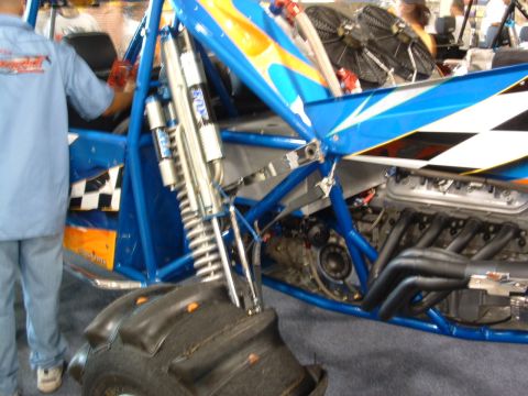 1993 Ford Taurus - A close-up view reveals the intricate details of a racing vehicle's engine and suspension system, highlighting its performance components.