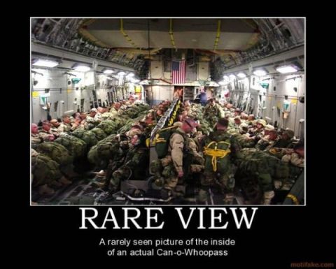 1988 Ford Bronco - A large group of soldiers are seated inside a military transport aircraft, preparing for a mission.