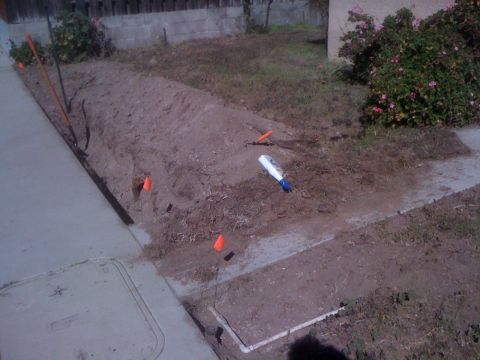 1968 Ford Mustang - A scene depicting a construction area marked with orange flags and a shovel, suggesting recent digging or landscaping work.