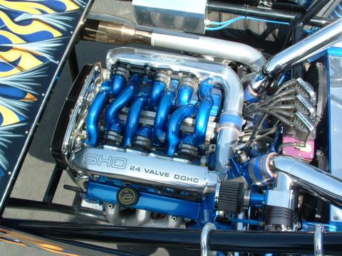 1993 Ford Taurus - The engine bay features a custom Ford SHO V6 engine with vibrant blue accents and polished components.
