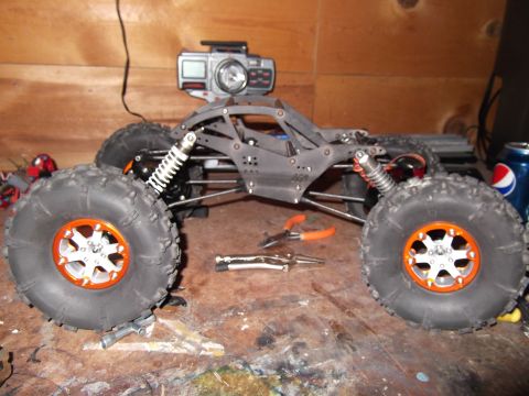 1989 Ford Bronco - This remote control rock crawler features large, off-road tires and an action camera mounted to its chassis.