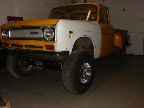 1971 International School Bus - International pickup truck, likely a 1971 model, modified with a lift kit and oversized tires.