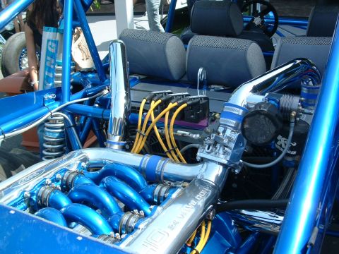 1993 Ford Taurus - Close-up of a custom dune buggy's engine bay, highlighting its blue and chrome components.