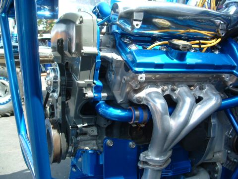 1993 Ford Taurus - Customized engine bay features a bright blue finish on the valve covers and intake piping, complemented by polished exhaust headers.