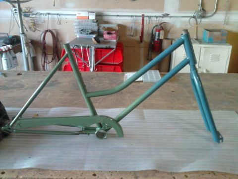 1994 Ford F-150 - Bicycle frame undergoing restoration or painting in a workshop setting.