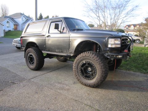 1996 Ford Bronco - This modified Ford Bronco features an aggressive stance with its lifted suspension and oversized tires.