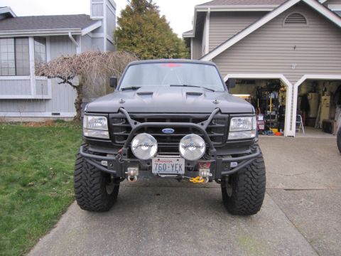 1996 Ford Bronco - This modified 1996 Ford Bronco is parked in a driveway in front of a garage.