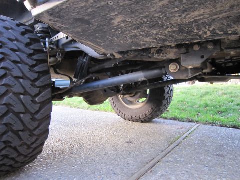1996 Ford Bronco - Close-up view of the underbody and suspension of a modified off-road vehicle.