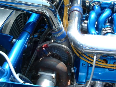 1993 Ford Taurus - Close-up view of a modified engine bay, highlighting custom turbocharger and exhaust components.