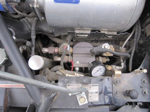 1996 Ford Bronco - This image shows a detailed view of engine components, including fuel lines and a pressure gauge.