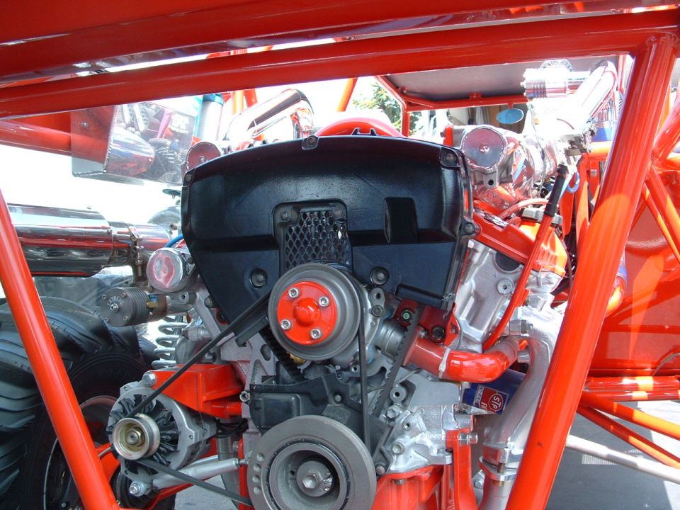 Engine with red accents and black cover, viewed from the front