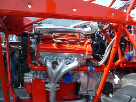 1993 Ford Taurus - Custom racing engine with polished exhaust headers and intake manifold, painted bright orange.