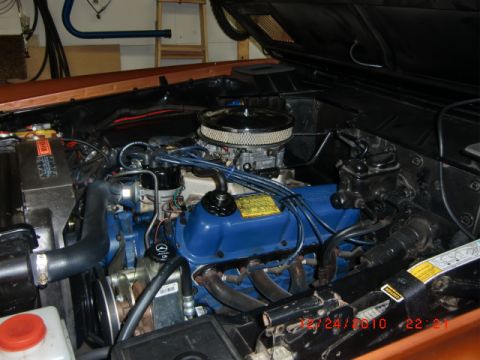 1973 Ford Bronco - Close-up view of the engine bay, blue valve covers and a chrome air cleaner assembly.