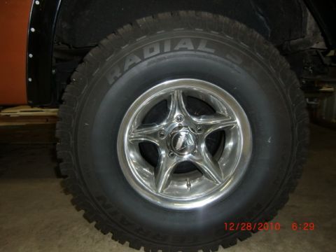 1973 Ford Bronco - Close-up view of a chrome wheel and tire on an off-road vehicle.