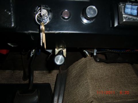 1973 Ford Bronco - Interior view of a vehicle's dashboard, showing the ignition, radio, and pedals.