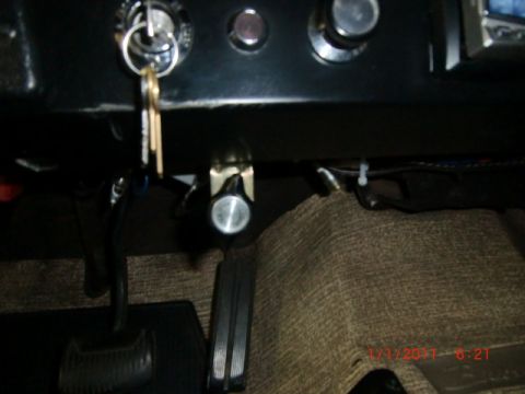 1973 Ford Bronco - Interior view of a vehicle showing the ignition, pedals, and floor mats.