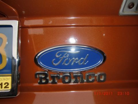 1973 Ford Bronco - Close-up of Ford Bronco emblem on an orange vehicle. Date stamp shows 1/1/2011.
