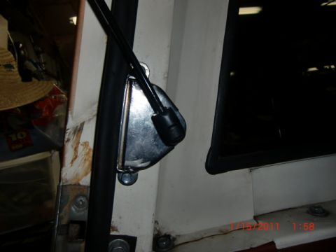 1973 Ford Bronco - A close-up view of the interior door latch mechanism and surrounding frame of a vehicle.