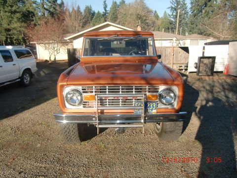 1973 Ford Bronco - Front view of a 1973 Ford Bronco, parked outdoors next to a white SUV.