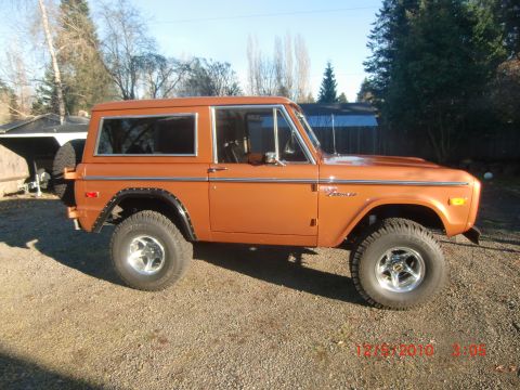 1973 Ford Bronco - This 1973 Ford Bronco is shown from a 3/4 front angle, parked outdoors on a gravel surface.