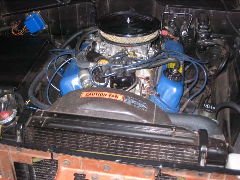 1973 Ford Bronco - Close-up view of an engine bay, blue valve covers and a prominent air filter assembly.