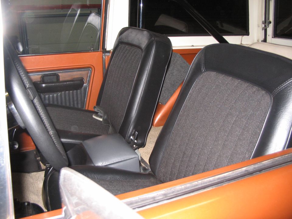 1973 Ford Bronco interior with orange door panels and black seats