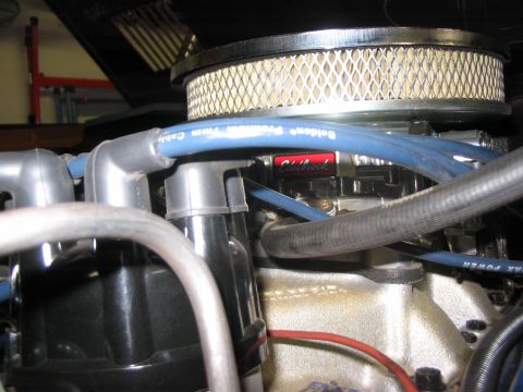 1973 Ford Bronco - Engine bay detail showing an air cleaner, distributor cap, and spark plug wires with an Edelbrock component visible.