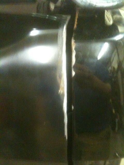 1993 Ford Bronco - The image shows a close-up view of a damaged seam between two vehicle body panels.