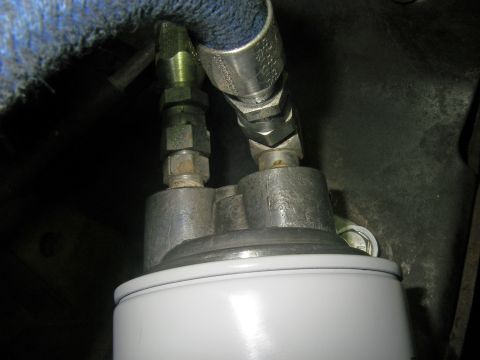 1990 Ford Bronco - Close-up view of an oil filter assembly with connected hoses.