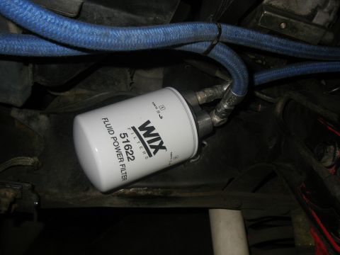 1990 Ford Bronco - Close-up of a WIX fluid power filter with braided hoses connected.