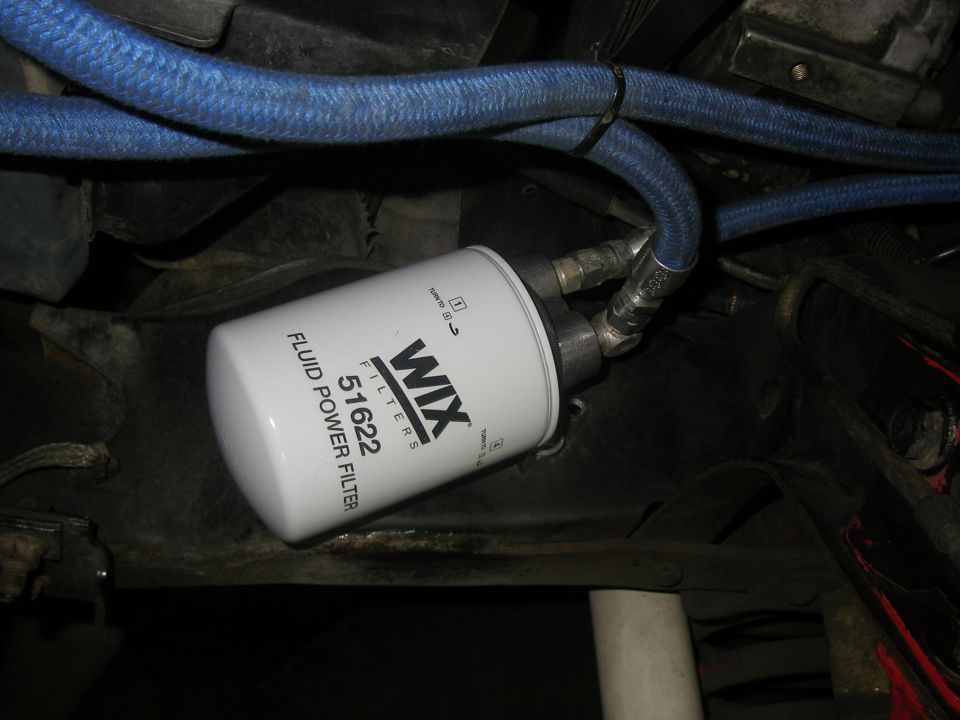 WIX Filters 51622 fluid power filter with blue braided hoses attached