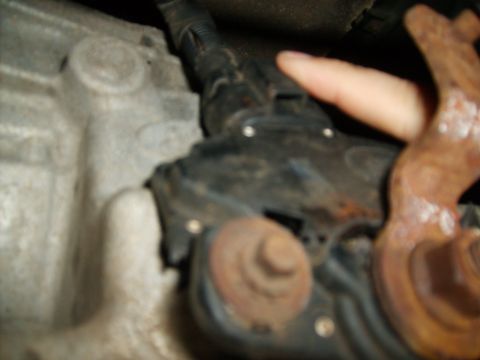 1995 Ford Bronco - A close-up view of a vehicle's transmission housing and electrical connectors.