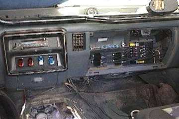 1991 Ford Bronco - Interior view of a Ford Bronco showing the dashboard, exposed wiring, and a SuperMotors logo on the lower right.
