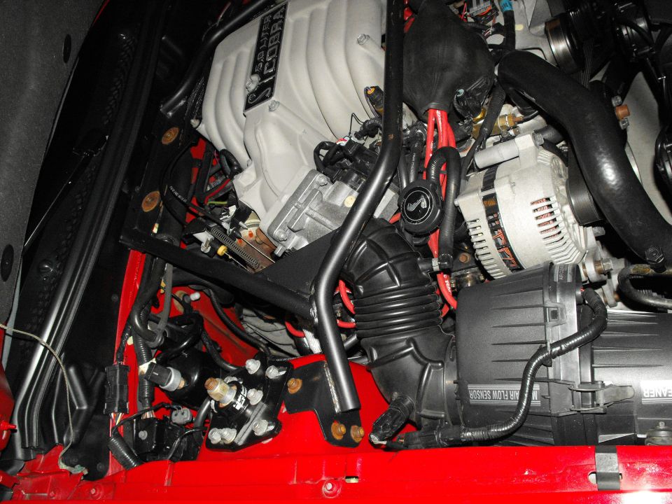 engine bay with "COBRA" intake manifold and "AIR FLOW SENSOR" label visible