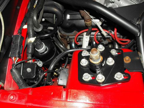 1994 Ford Bronco - Close-up view of engine bay components, including wiring and a suspension strut mount.