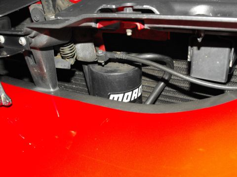 1994 Ford Bronco - Close-up of a Moroso oil filter in a red vehicle's engine bay.