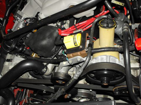 1994 Ford Bronco - Close-up of engine components including power steering pump and ignition coil.